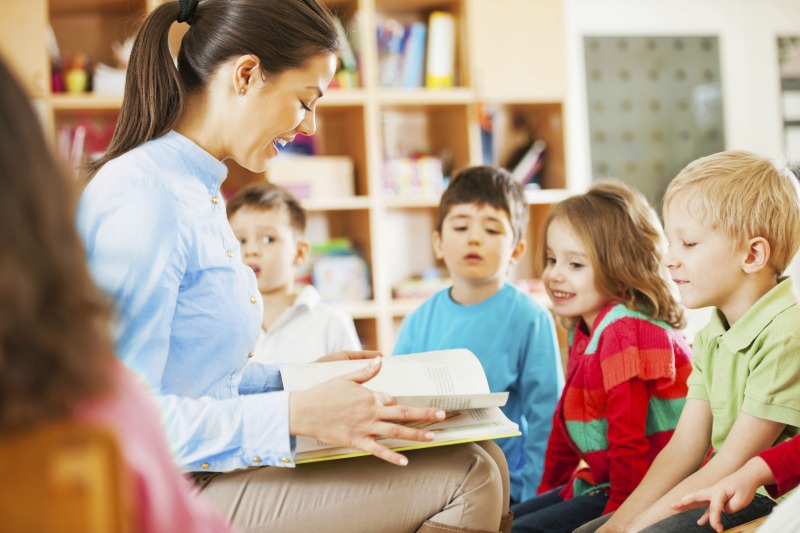 kindergarten teacher reading to children SMALL